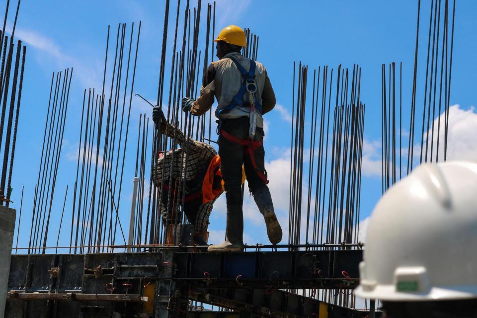 two people on roof surrounded by rebar