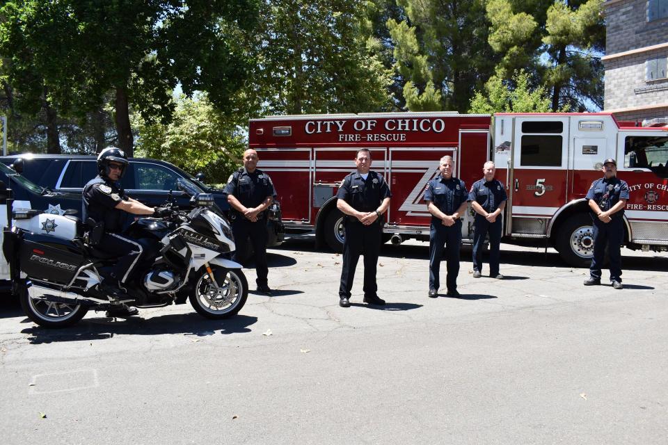 Police Officers standing in front of a fire engine