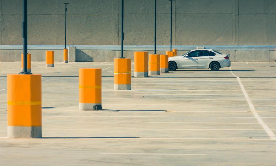 White car parked in an empty parking lot
