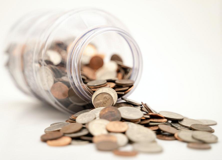 coins spilling out of jar